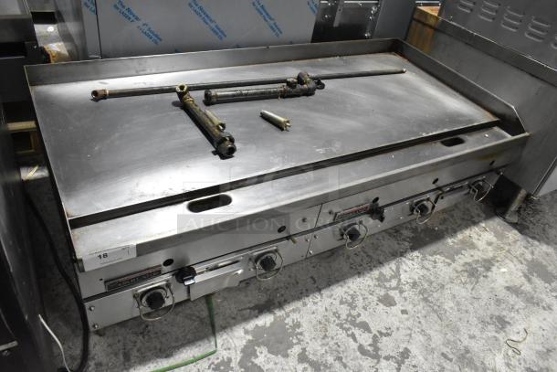 Garland stainless steel commercial gas griddle, countertop model, four knobs, moderate wear, needs parts adjustment.