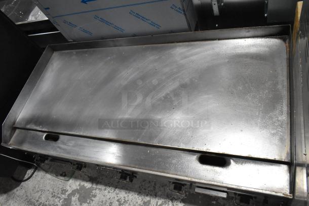 Garland stainless steel commercial countertop gas griddle, used condition, features flat cooking surface and adjustable knobs.