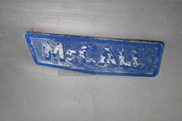McCall PTA-3 Stainless Steel Pizza Prep Table, visible wear on label, commercial casters, 115 volts, 1 phase.