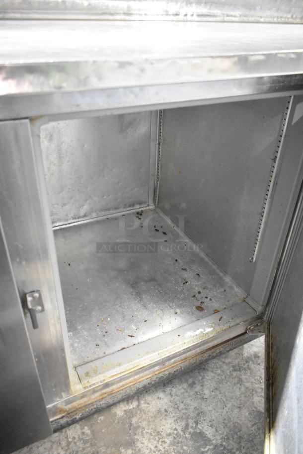 McCall PTA-3 stainless steel commercial pizza prep table, interior view, used condition, on commercial casters.