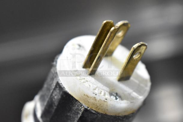 Close-up of a plug for the McCall PTA-3 Stainless Steel Commercial Pizza Prep Table, showcasing electrical compatibility.