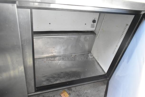 True TUC-60 undercounter cooler, stainless steel, 2 doors, on commercial casters, 115V, 1 phase, interior view.