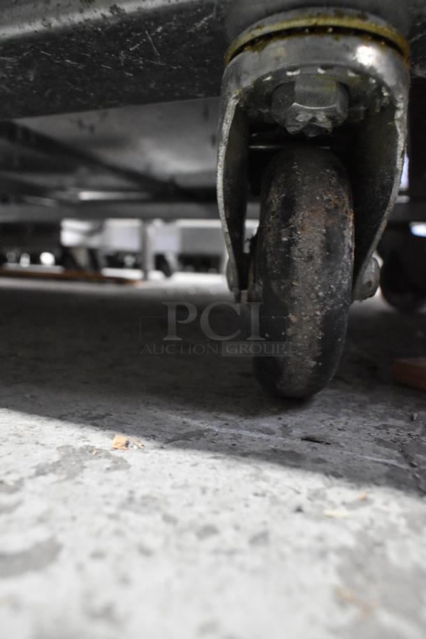 Close-up of a wheel from a 2021 Padela PDB-2F-HC Stainless Steel Commercial Freezer. Missing doors, 115 volts, 1 phase.