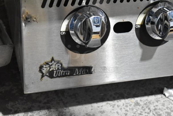 Star Ultra Max Stainless Steel Gas Charbroiler Grill, featuring dual knobs and branded logo. Visible wear near logo.