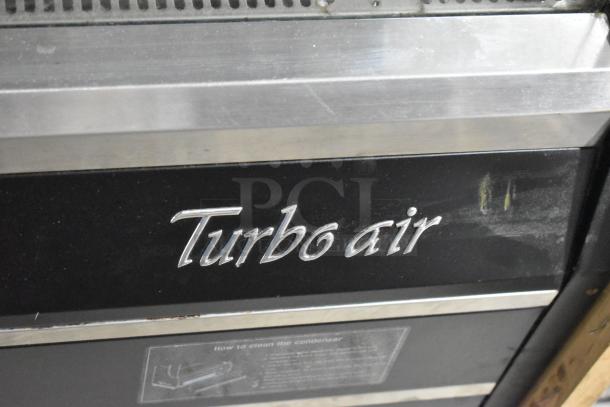 Turbo Air TOM-40MB merchandiser, metal shelves, 120V, 1-phase, logo visible, some surface wear, cleaning instructions attached.