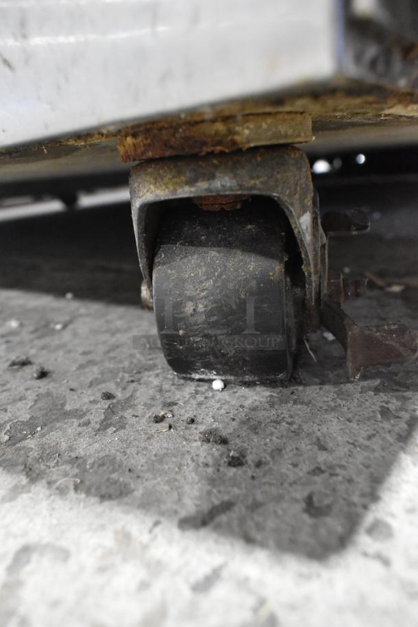 Rusty caster of 2017 Hoshizaki CF2S-FS stainless steel commercial freezer, highlighting wear on commercial wheels.