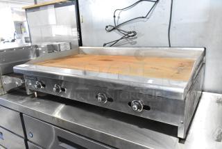 Radiance stainless steel commercial gas griddle, flat top, 3 knobs, worn condition, visible brown rust on surface.
