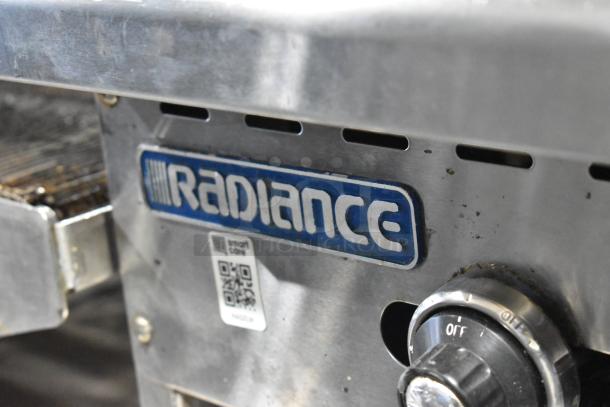 Radiance stainless steel commercial gas griddle with control knob, brand logo, and QR code visible, in used condition.