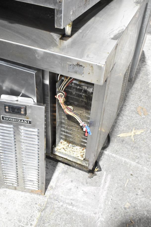 Hoshizaki stainless steel 4-drawer chef base, commercial casters, 115 volts, 1 phase. Visible wear, wiring exposed.