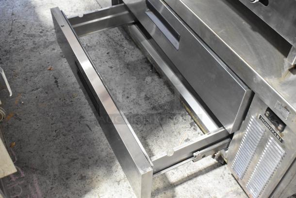 Hoshizaki stainless steel 4-drawer chef base on casters, 115V, 1 phase, featuring commercial-grade construction and brand plaque.