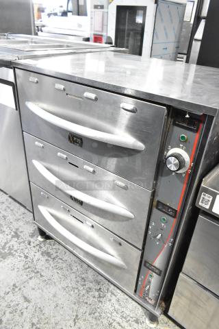 APW Wyott HDDi-3-120-4L-S stainless steel 3-drawer warming drawer, commercial grade, 120V, 1 phase, with control panel.