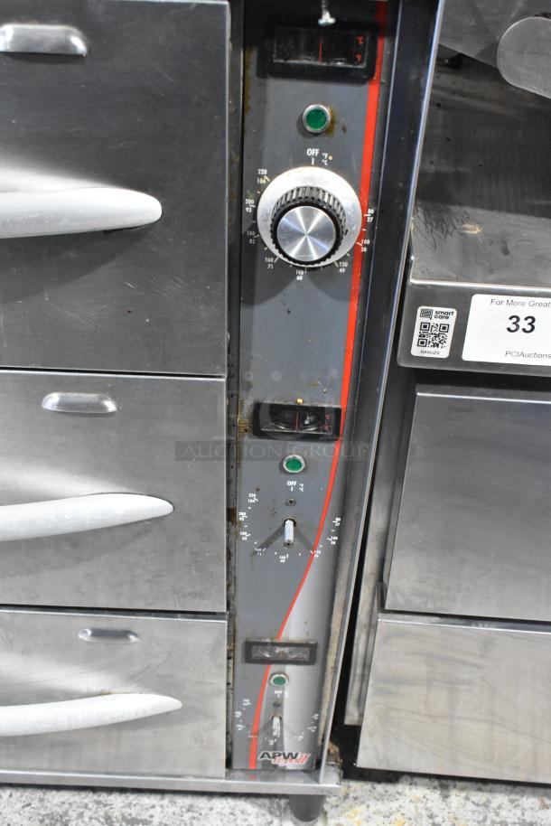 APW Wyott HDDi-3-120-4L-S stainless steel 3-drawer warming drawer, 120 volts, control knobs, visible wear.