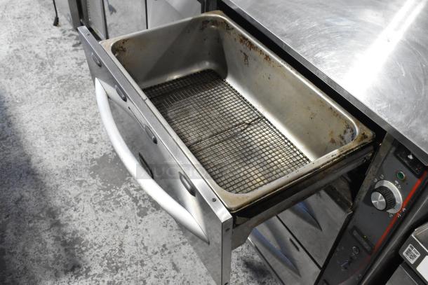 APW Wyott HDDi-3-120-4L-S stainless steel 3-drawer warming drawer, 120 volts, commercial use. Visible wear.