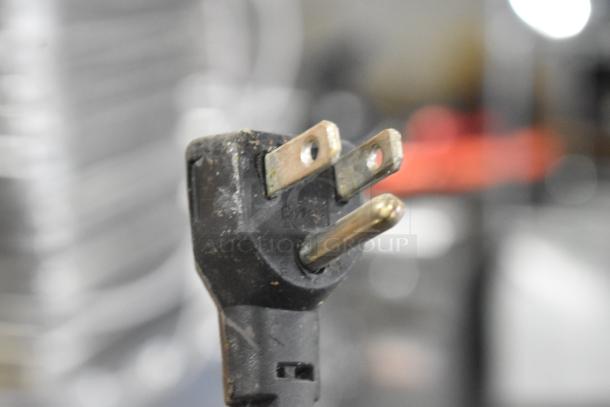 Close-up of a power plug for APW Wyott HDDi-3-120-4L-S warming drawer, showing three-prong configuration.