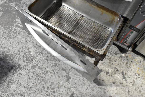 APW Wyott HDDi-3-120-4L-S stainless steel warming drawer, 3 drawers, 120 volts, visible wear, ideal for commercial use.
