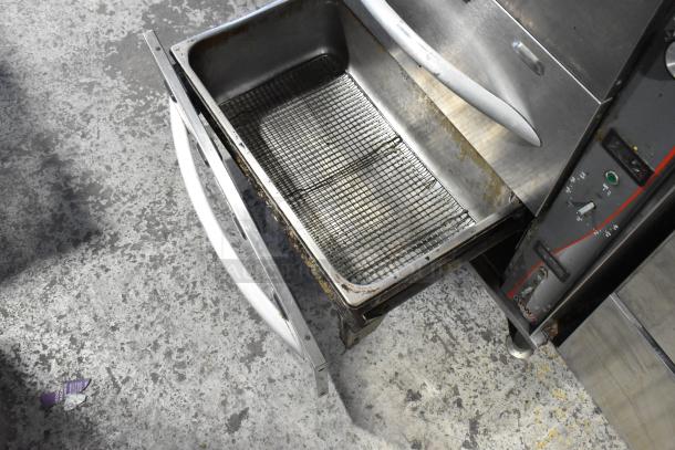 APW Wyott HDDi-3-120-4L-S warming drawer, stainless steel, 3 drawers, visible interior racks, used condition. 120 volts, 1 phase.