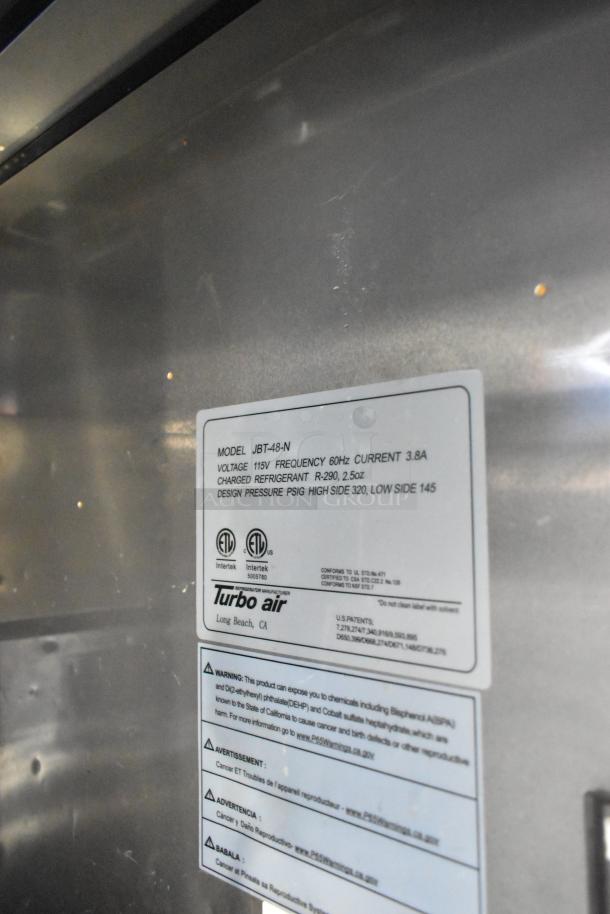 Turbo Air JBT-48-N stainless steel refrigerated buffet table label, showing voltage, refrigerant type, and safety warnings.