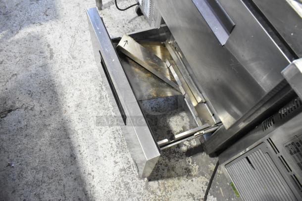 Stainless steel 2-drawer undercounter cooler, 115 volts, 1 phase, commercial use, visible wear, sturdy metal construction.