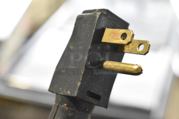Close-up of a three-prong plug for the Silver King Stainless Steel Commercial Chest Cooler or Freezer, 115 Volts, 1 Phase.
