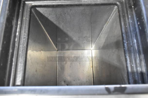 Silver King stainless steel commercial chest cooler interior, showing clean, shiny surfaces. Equipped with commercial casters.