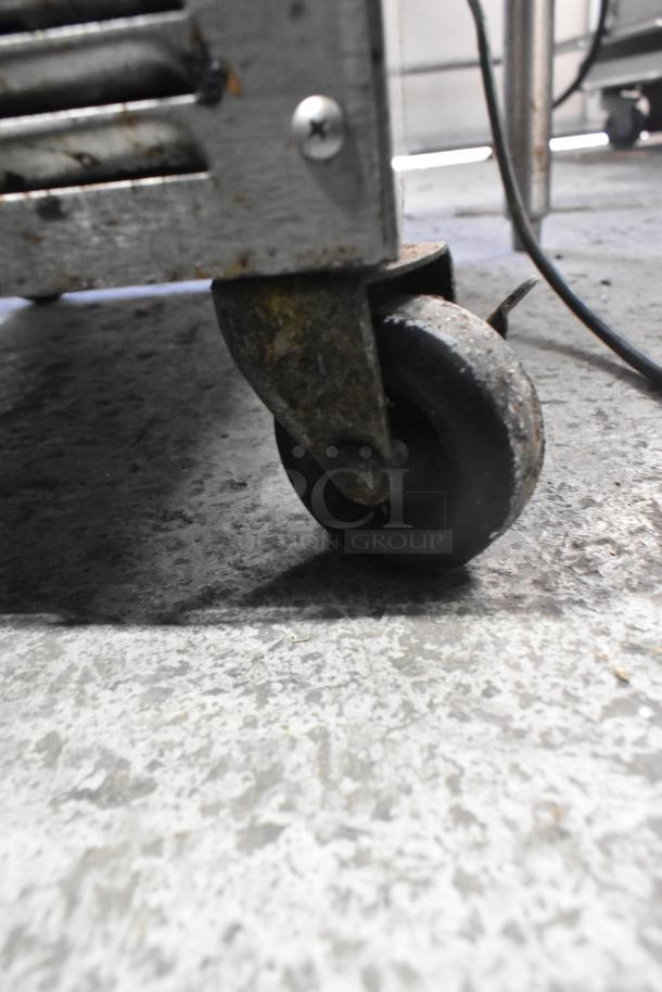 Silver King stainless steel commercial chest cooler/freezer on worn commercial caster, 115V, 1 phase, shown close-up.