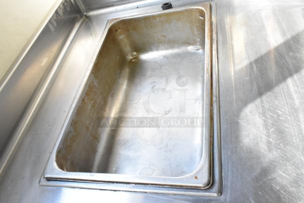 APW Wyott stainless steel 2 well steam table, 115 volts, 1 phase, used, with visible wear in wells, commercial use.