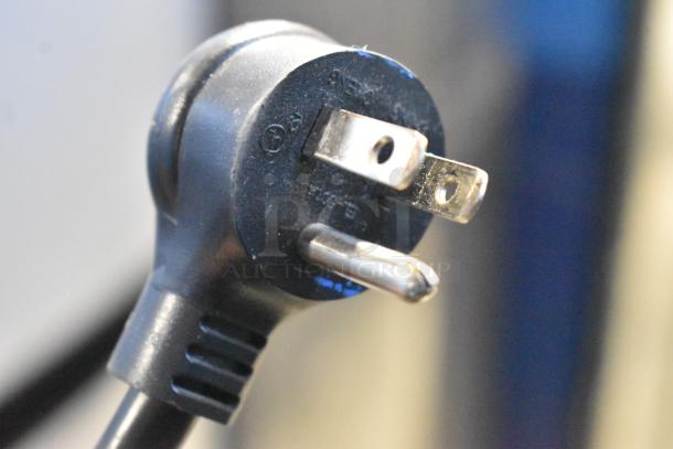 Close-up of a three-pronged black electrical plug, part of the 2017 True T-19F commercial freezer.