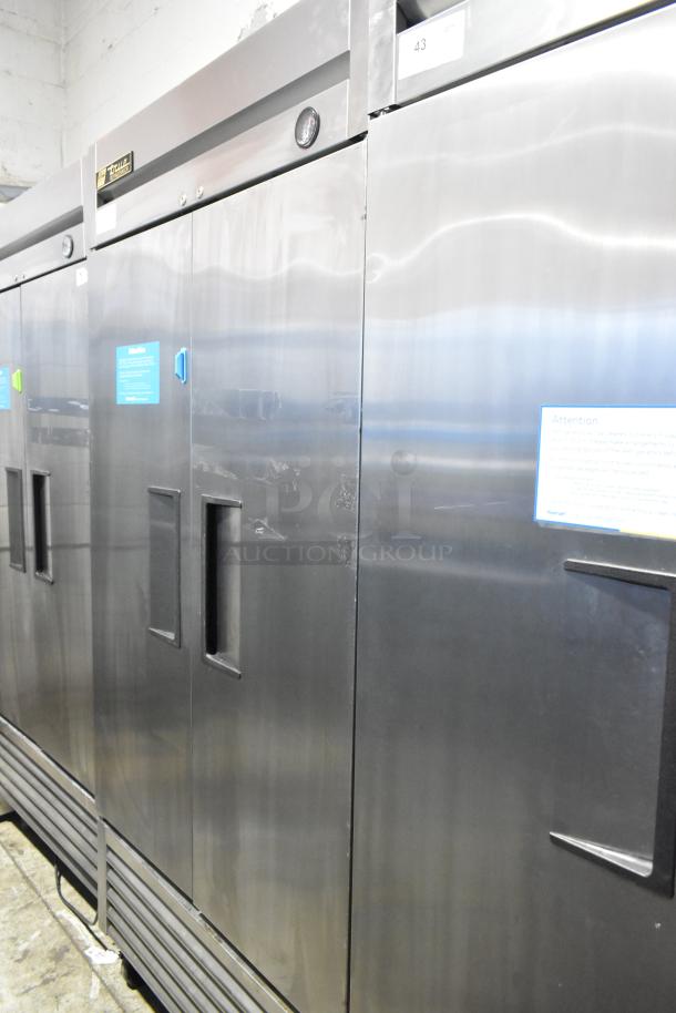 True T-35 stainless steel commercial 2-door reach-in cooler with poly-coated racks on casters, 115V, well-maintained.