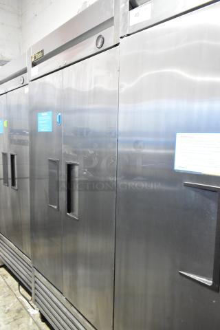 True T-35 stainless steel commercial 2-door reach-in cooler with poly-coated racks on casters, 115V, well-maintained.