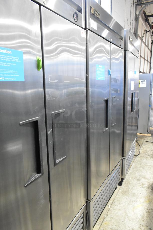 True T-35 stainless steel commercial 2-door reach-in cooler with poly-coated racks, on casters. 115V, 1 phase.