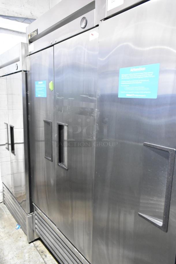 True T-35 stainless steel 2-door reach-in cooler, commercial casters, poly coated racks, 115V, 1 phase, visible caution label.