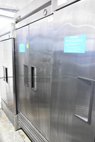 True T-35 stainless steel 2-door reach-in cooler, commercial casters, poly coated racks, 115V, 1 phase, visible caution label.