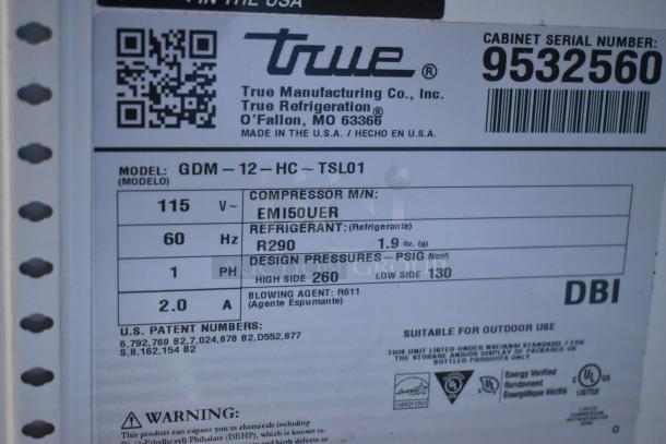 True GDM-12-HC reach-in cooler label, 115V, with compressor info, energy specifications, patent numbers, and safety warnings.