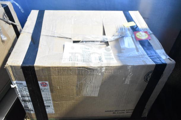 Cardboard box labeled Nema HD98 Motor, 230/460 Volts, 3 Phase. Slightly worn with shipping labels, black tape sealing.