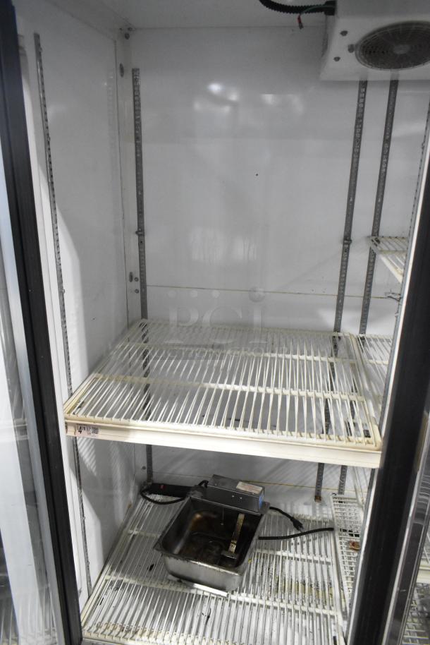 Zero Zone TA30AWCF 3-door commercial cooler with poly-coated racks. Metal construction, 115V, 1-phase. Clean interior.