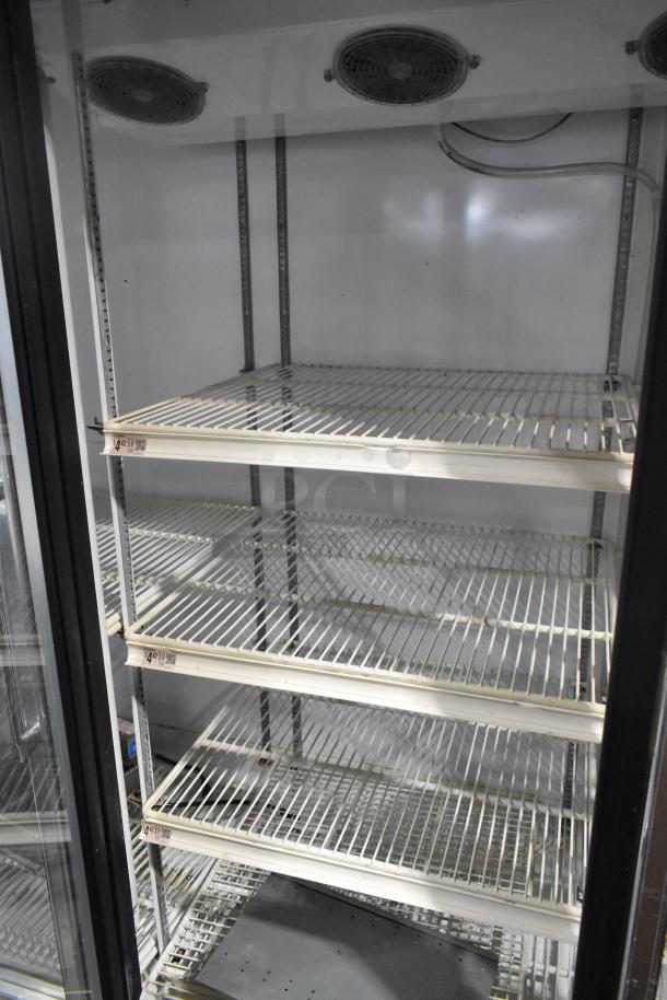 Zero Zone TA30AWCF commercial 3-door reach-in cooler with poly-coated racks, 115V, 1 phase, metal construction.