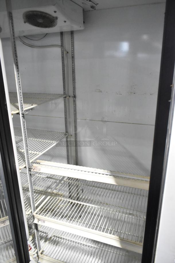 Zero Zone TA30AWCF metal commercial 3-door cooler with poly-coated racks, 115V, 1-phase, in good condition.