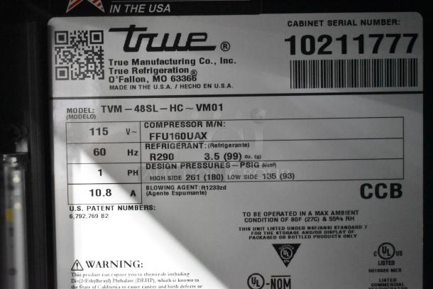 2021 True TVM-48SL-HC 2 door reach-in cooler, 115V, metal shelves. Label shows model, compressor and refrigerant specs.