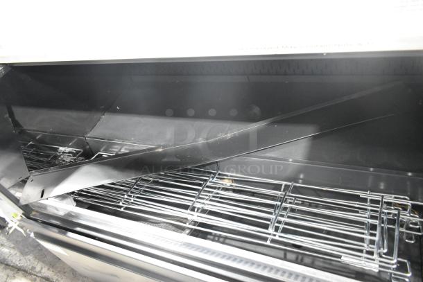 Structural Concepts metal commercial horizontal open merchandiser with top display case, featuring shelving and black finish.