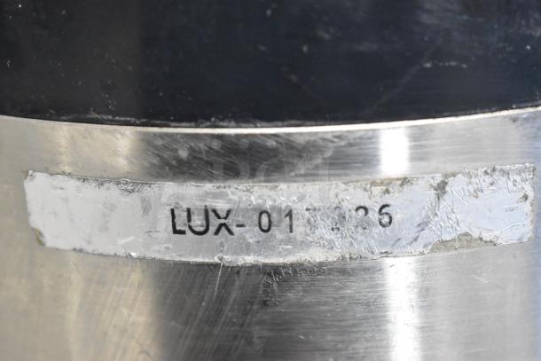 Fetco Stainless Steel Beverage Dispenser close-up showing partial marking "LUX-01" on the metal surface.