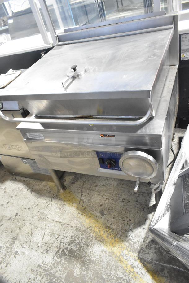 Cleveland stainless steel gas-powered braising pan, manual tilt, floor style, with control knobs and handle. Good condition.