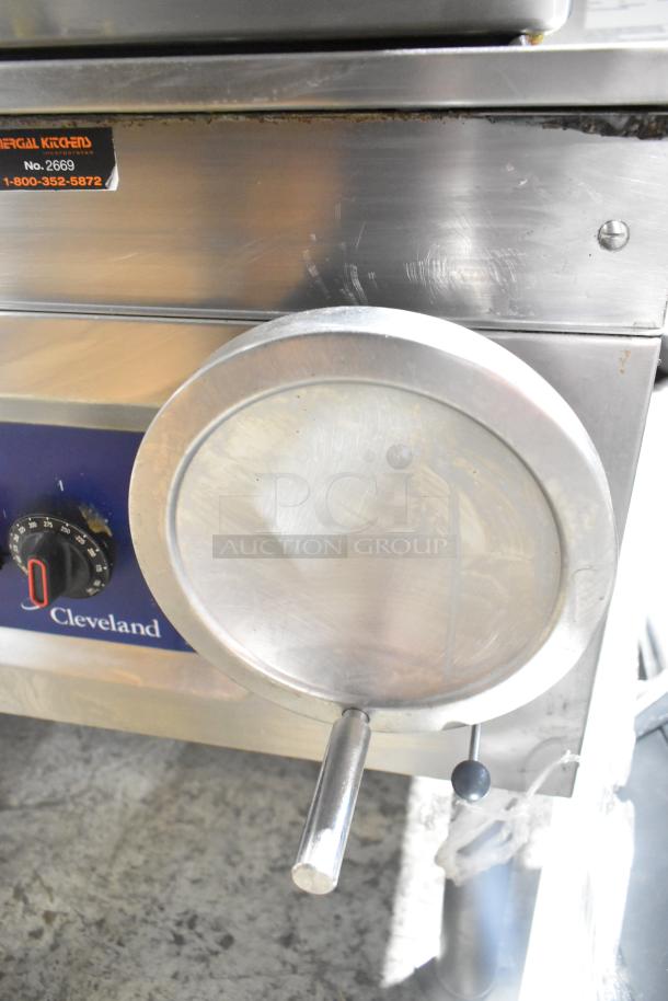 Cleveland stainless steel commercial gas braising pan, manual tilt, floor style, visible controls and logo. Moderate wear.