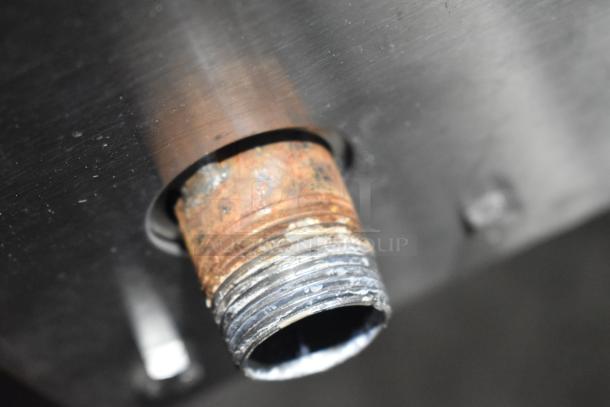 Close-up of a rusted pipe connection on a Cleveland KGL-40-T commercial steam kettle, indicating wear.