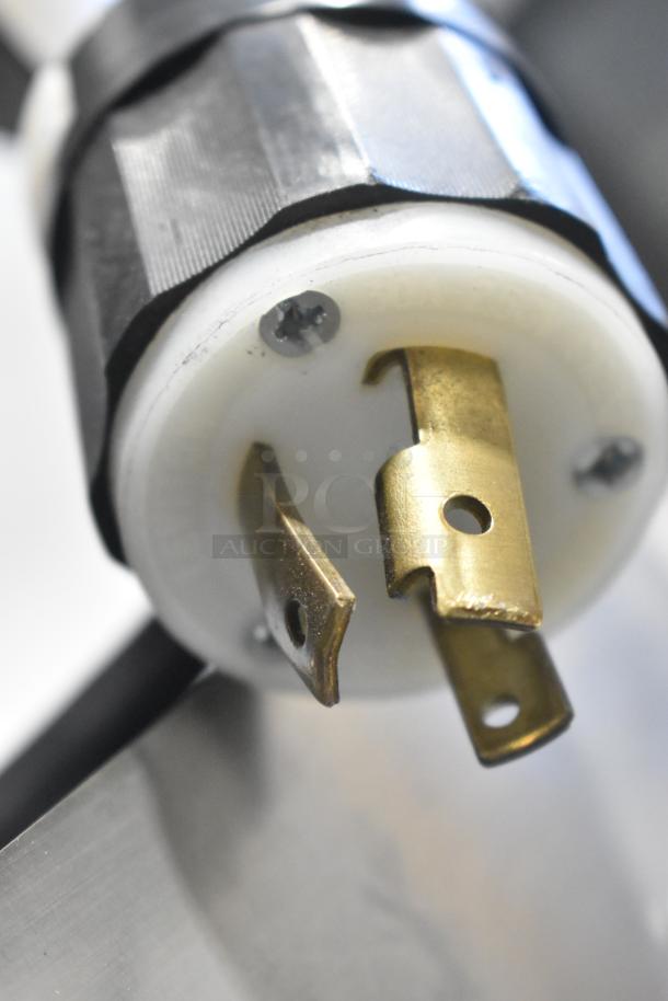 Close-up of a plug on the 2024 Follett HMC1410WBT stainless steel commercial ice machine, 1475 lbs/day, 208-230V, 1 phase.