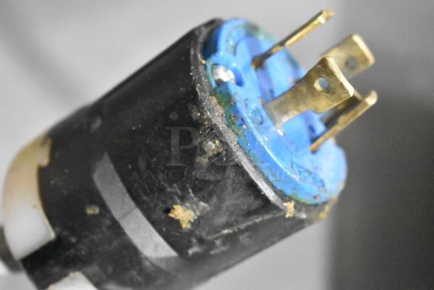 Close-up of a power plug for the Desmon GBF-15+ETL blast chiller. Features brass prongs and signs of wear.