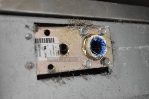 Stainless steel base of Scotsman C1030MA-32F ice machine, showing maintenance area with wear and labeling.