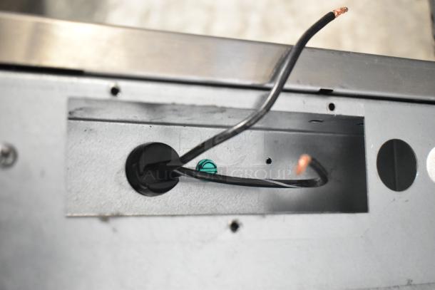 Close-up of wiring section in a Scotsman C1030MA-32F stainless steel ice machine, showing exposed wires and mounting holes.