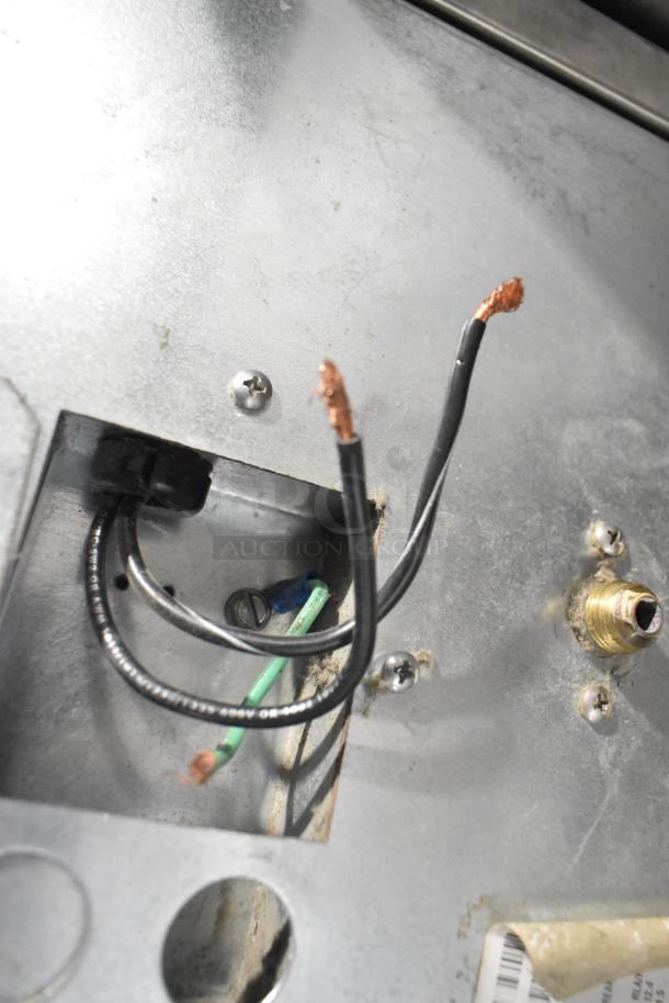 Scotsman CME806AS-32F ice machine internals showing wiring and metal casing, for 208/230V, 1 phase connection.
