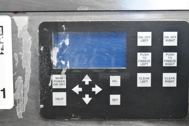 Stoelting SF121-38I2 control panel close-up, buttons for power, cleaning, freezing, and settings visible, showing wear.