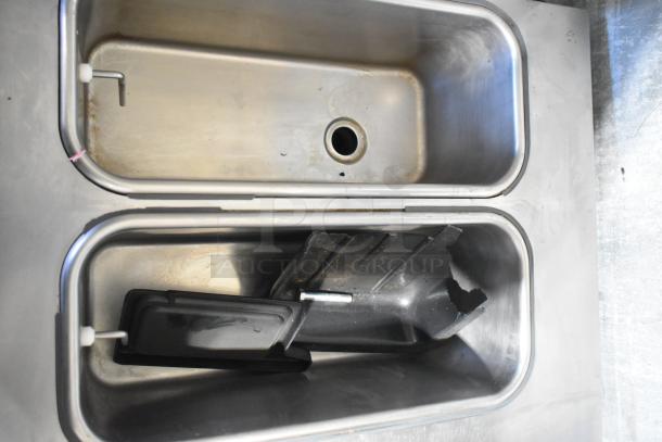 Stoelting SF121-38I2 stainless steel soft serve ice cream machine interior, showing two compartments, with visible wear.